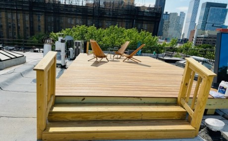 Modified rooftop deck with IPE deck board.There are many different types of boards . your choice and we install them.